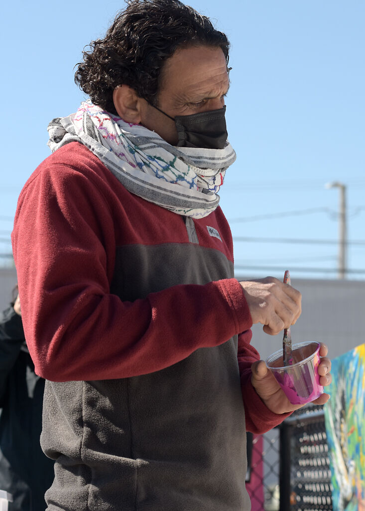 Yousef Darkhalil looks at the mural